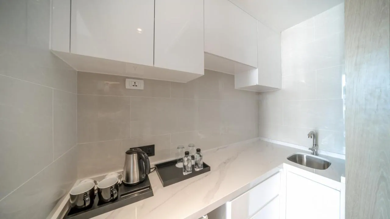Wyndham La Vita, Phuket: white kitchen cabinetry in a one-bedroom residence